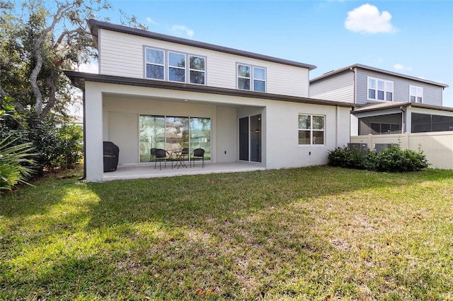 rear view of property with a patio area and a yard