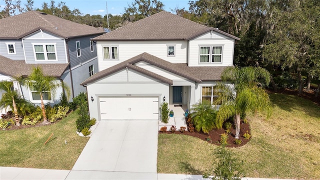 view of front of property featuring a front yard and a garage