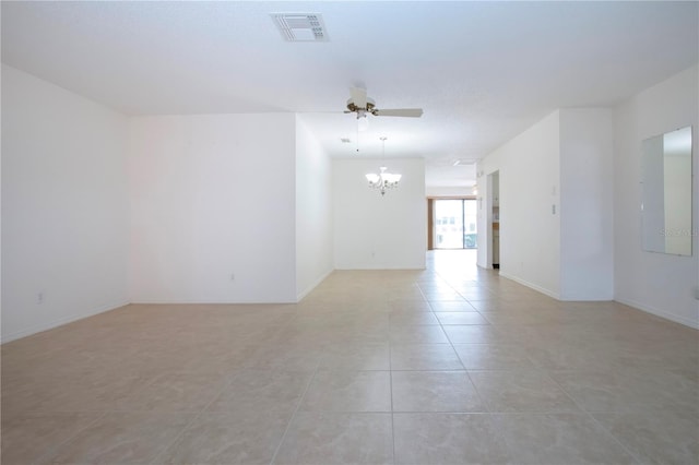 empty room with light tile patterned floors and ceiling fan with notable chandelier