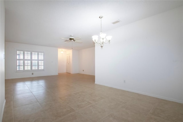 tiled empty room with ceiling fan with notable chandelier