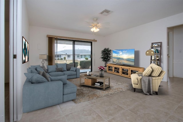 living room featuring ceiling fan and tile patterned floors