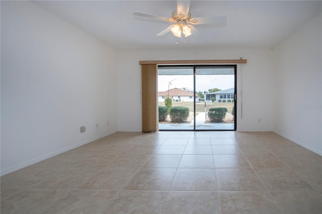 empty room featuring ceiling fan and light tile patterned flooring