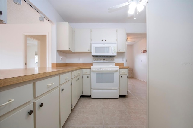 kitchen with light tile patterned flooring, ceiling fan, white cabinetry, and white appliances