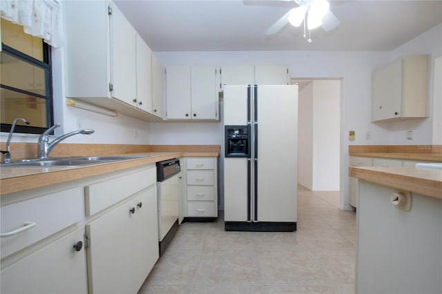 kitchen with light tile patterned flooring, dishwasher, white refrigerator with ice dispenser, white cabinets, and sink