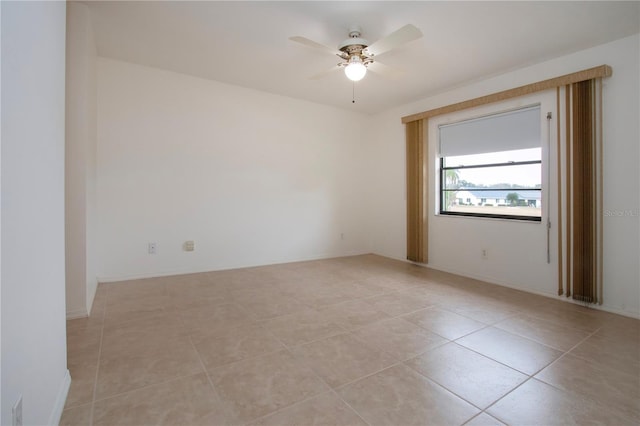 tiled empty room with ceiling fan