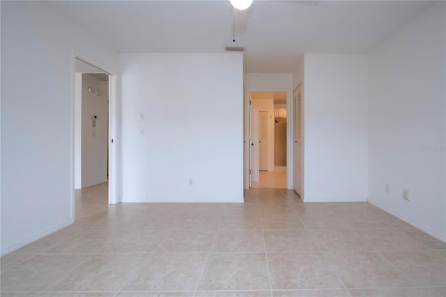 unfurnished room with ceiling fan and light tile patterned floors