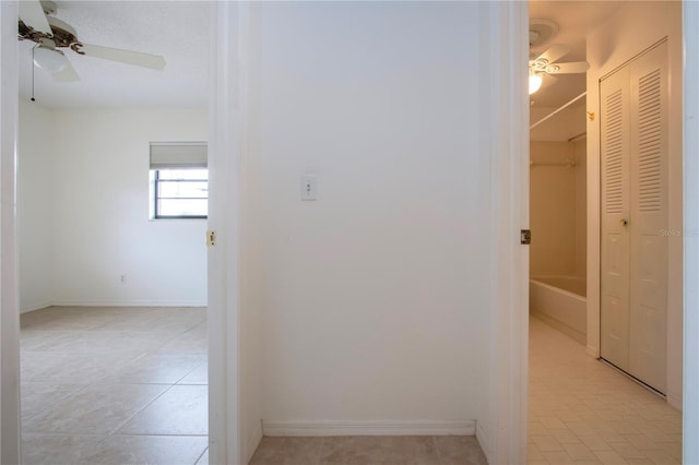 corridor featuring light tile patterned floors