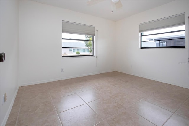 unfurnished room with ceiling fan and light tile patterned floors