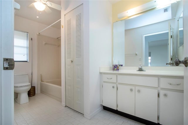 full bathroom with toilet, ceiling fan,  shower combination, and vanity