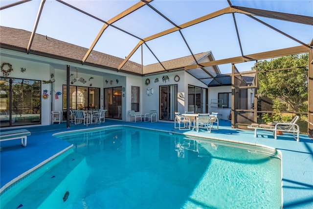 view of swimming pool featuring a lanai and a patio area