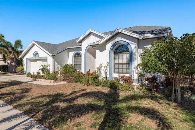 view of front of home featuring a garage and a front lawn