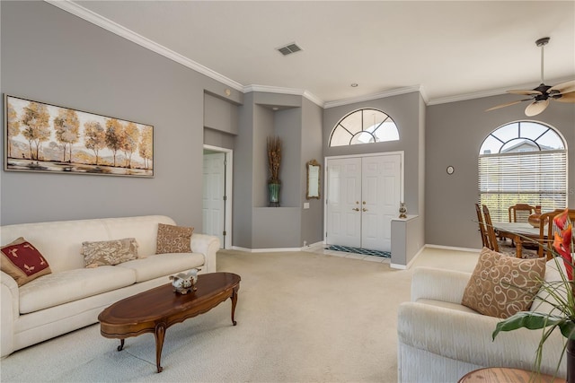 carpeted living room with crown molding, a wealth of natural light, and ceiling fan