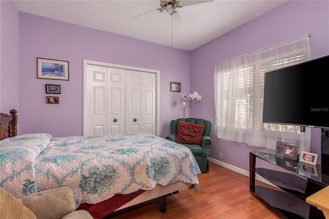 bedroom with hardwood / wood-style floors, ceiling fan, and a closet