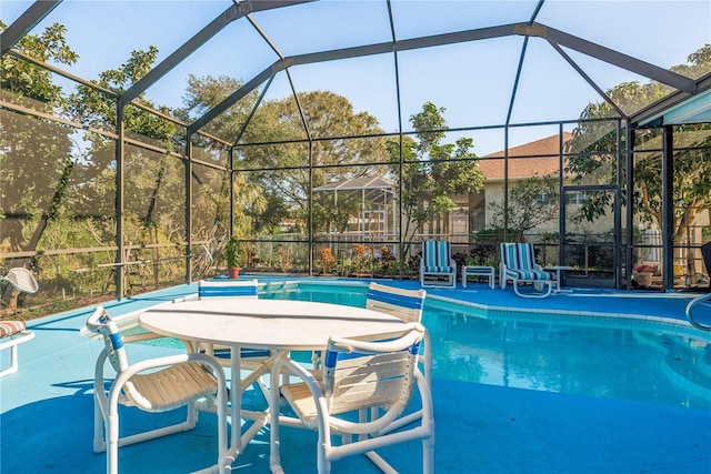 view of swimming pool with a lanai and a patio area