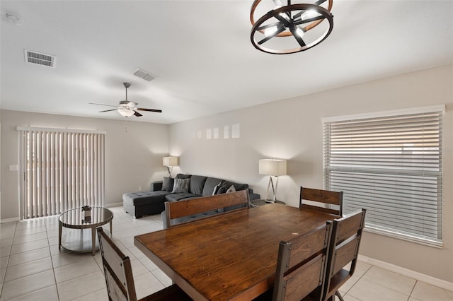 dining space featuring light tile patterned flooring and ceiling fan