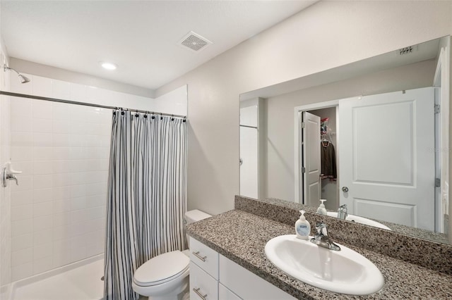 bathroom featuring vanity, toilet, and a shower with shower curtain