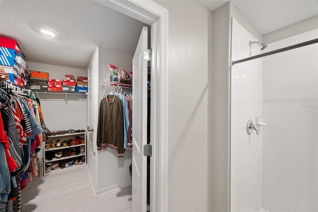 walk in closet with light wood-type flooring