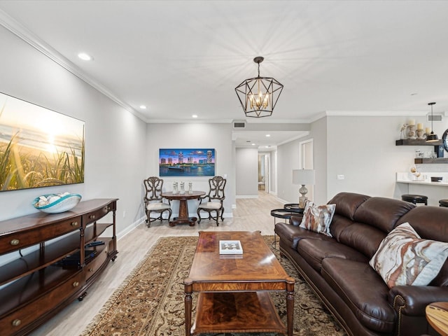 living room with ornamental molding, a chandelier, and light hardwood / wood-style flooring