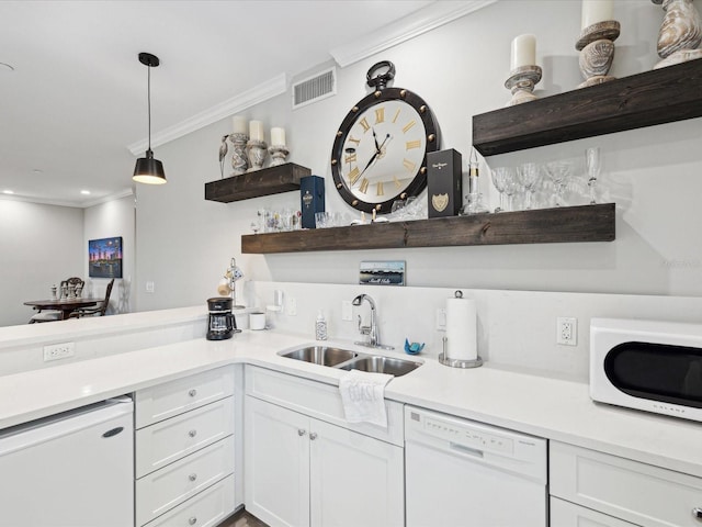 kitchen with pendant lighting, sink, white appliances, white cabinetry, and ornamental molding