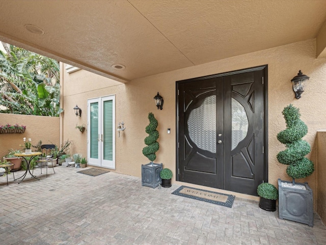 entrance to property with french doors and a patio area