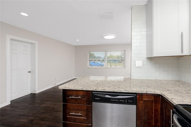 kitchen with white cabinets, dishwasher, light stone counters, and backsplash