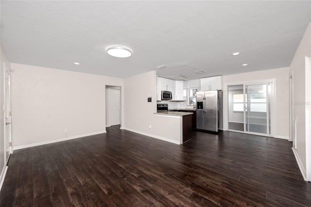 unfurnished living room with dark wood-type flooring and sink