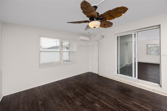 spare room featuring ceiling fan, hardwood / wood-style floors, and an AC wall unit