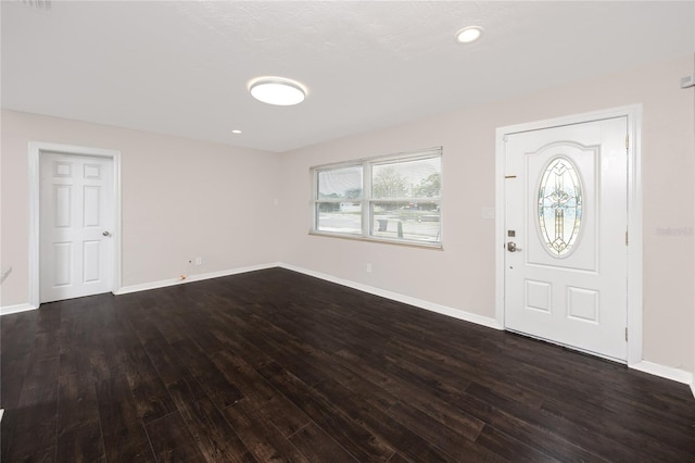 entryway with dark hardwood / wood-style flooring