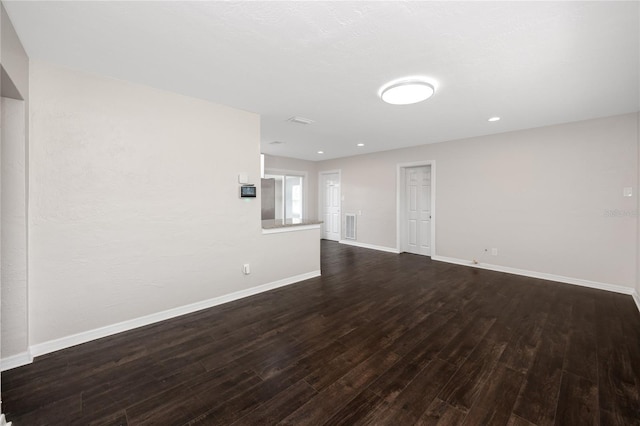 unfurnished living room with dark hardwood / wood-style floors