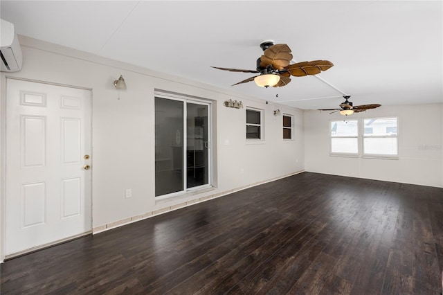 unfurnished living room with ceiling fan, a wall mounted AC, and dark wood-type flooring