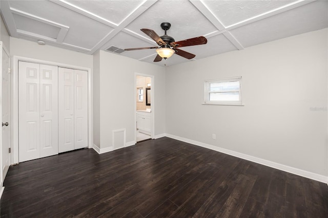 unfurnished bedroom with ceiling fan, connected bathroom, dark hardwood / wood-style floors, and coffered ceiling