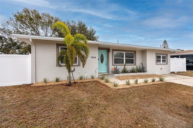 ranch-style home with a front yard