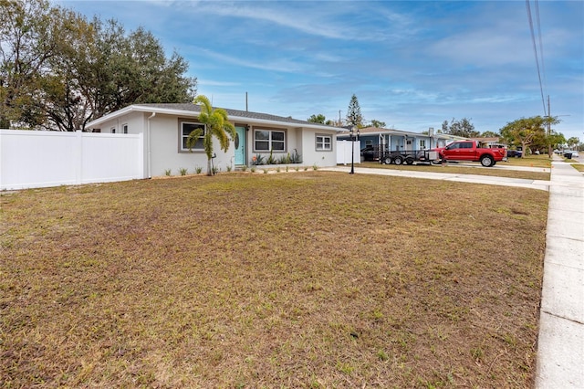 ranch-style house with a front lawn