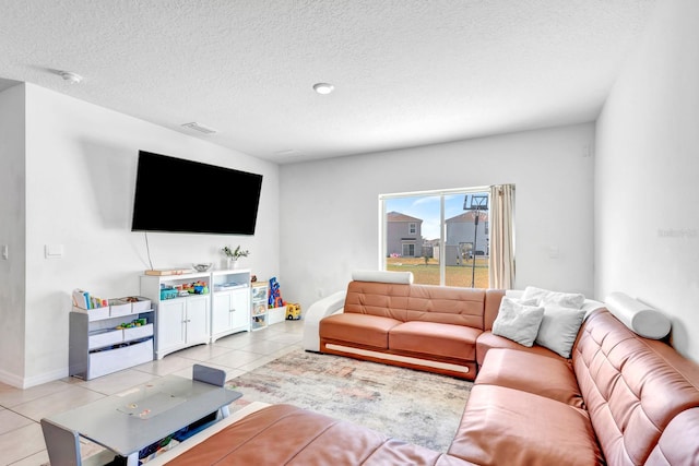 tiled living room featuring a textured ceiling