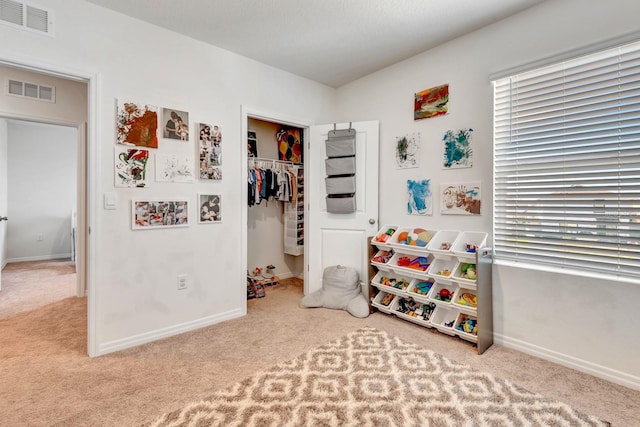 recreation room featuring light colored carpet