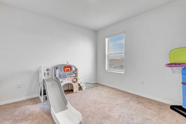 game room featuring light carpet