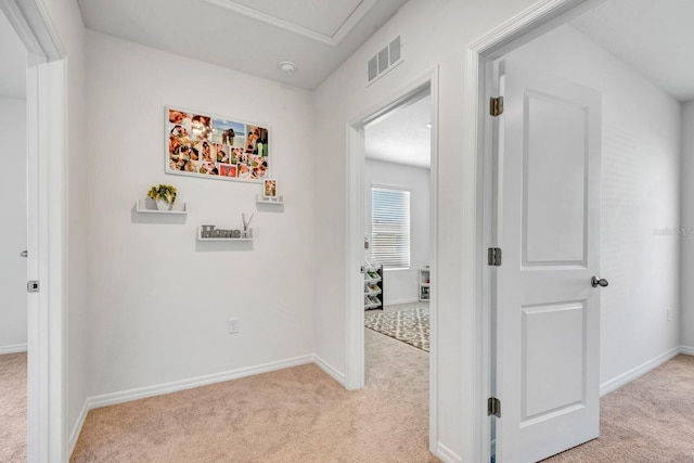 hallway with light colored carpet