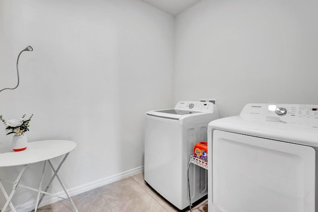 washroom with washing machine and dryer and light tile patterned flooring