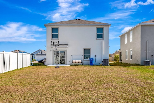 back of property featuring a yard and central air condition unit