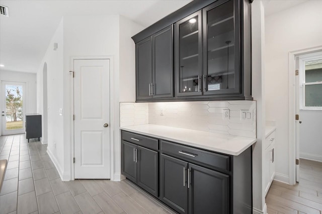 kitchen with backsplash and light hardwood / wood-style floors