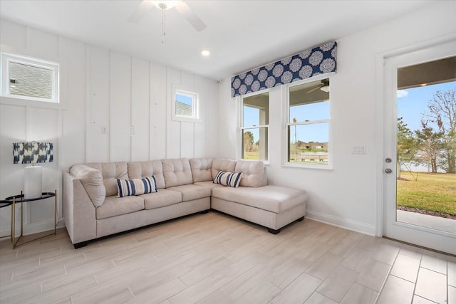 living room with plenty of natural light, ceiling fan, and light hardwood / wood-style floors