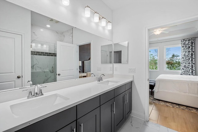 bathroom with vanity, a shower with door, and ceiling fan