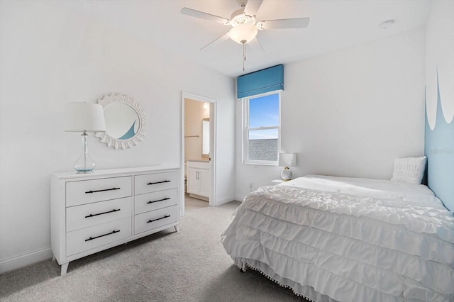 bedroom with ceiling fan, ensuite bathroom, and light carpet