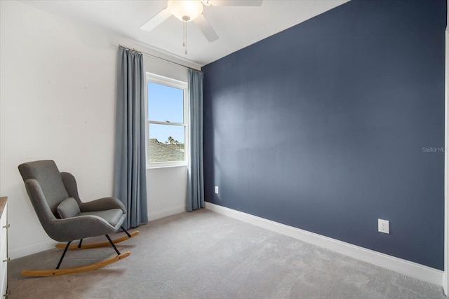 sitting room with light colored carpet and ceiling fan