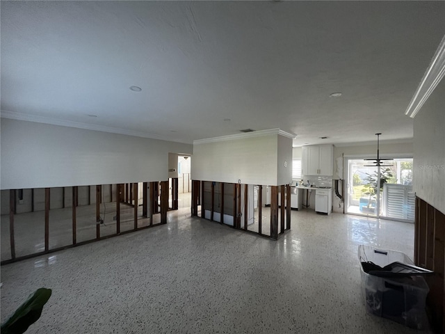 spare room with visible vents, light speckled floor, and crown molding