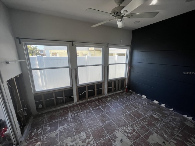 spare room featuring a wealth of natural light and a ceiling fan