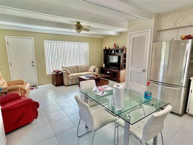 dining room featuring beam ceiling, ceiling fan, and light tile patterned flooring