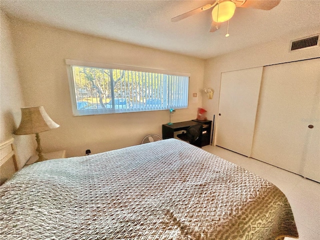 bedroom with ceiling fan and a closet