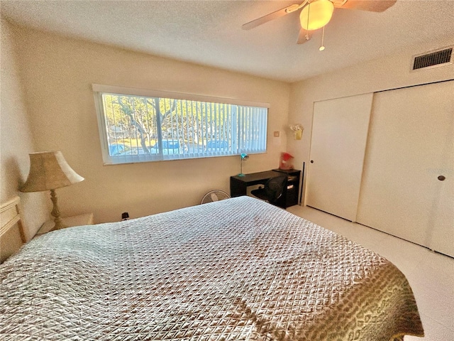 bedroom featuring ceiling fan and a closet