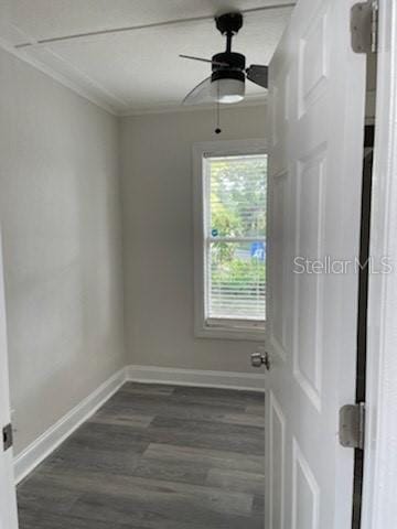 empty room with ceiling fan, crown molding, and dark hardwood / wood-style floors